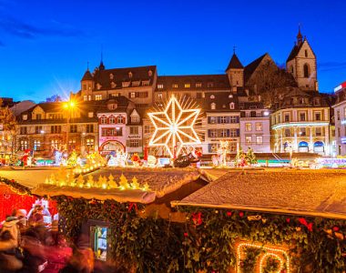 View over the christmas market at the Barfüssplatz in Basel, Switzerland, at dusk.